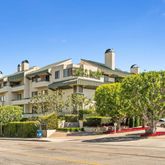 a view of a tall building next to a road
