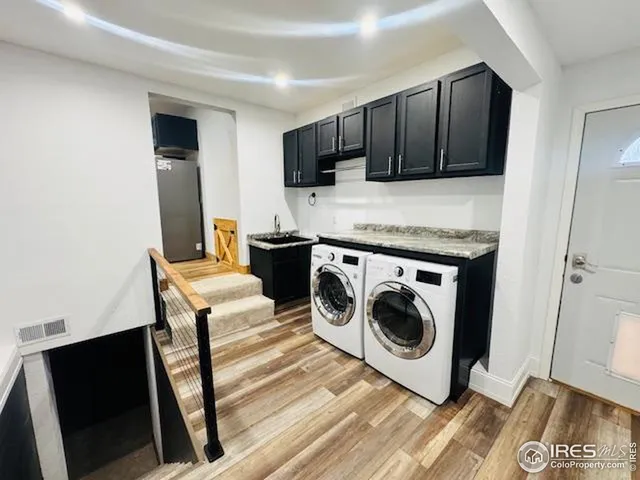 a utility room with sink dryer and washer