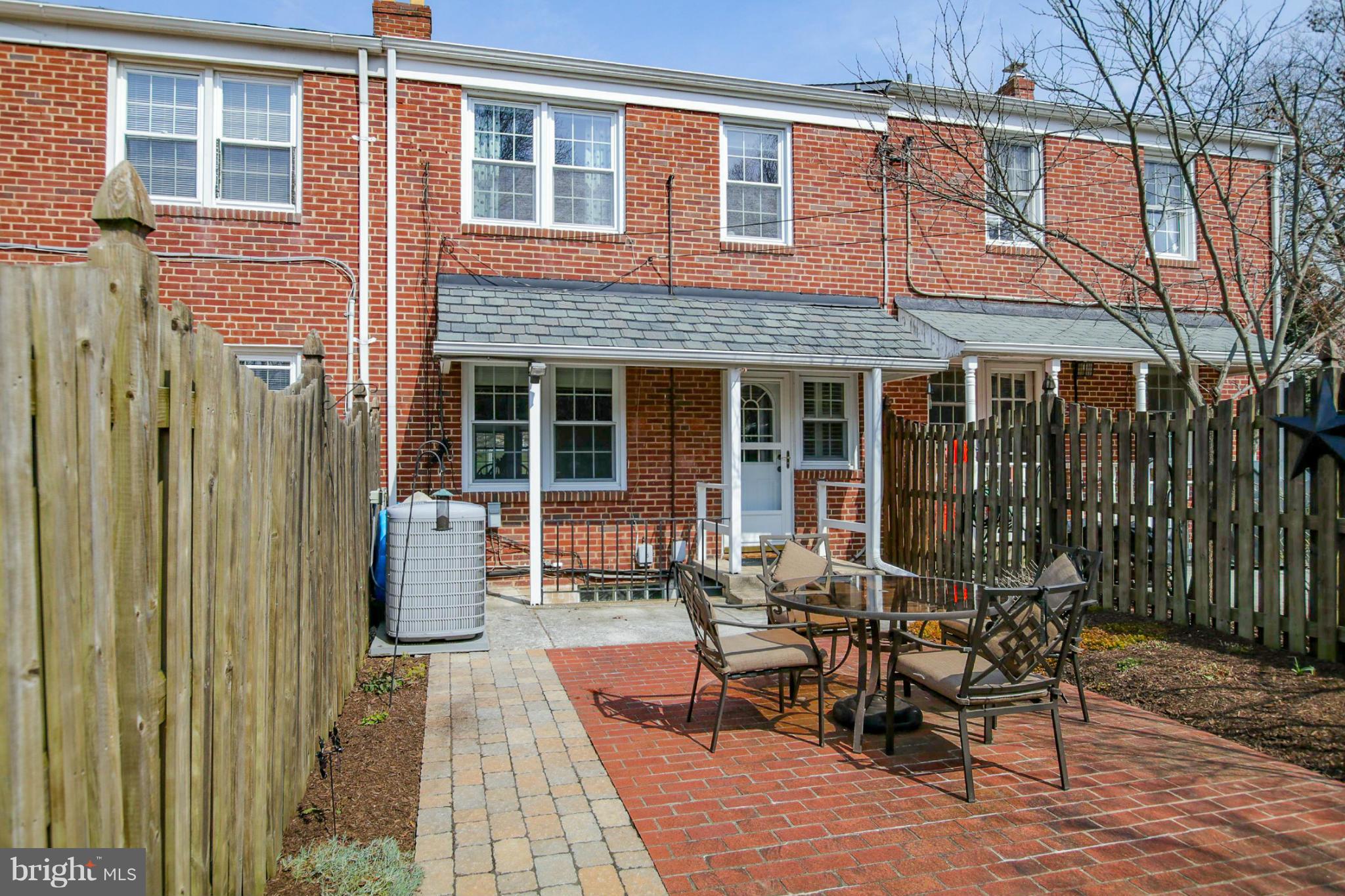 181 Dumbarton Road Baltimore, MD 21212 - Photo 29 of 30 a view of a brick house with a chairs and table in a patio