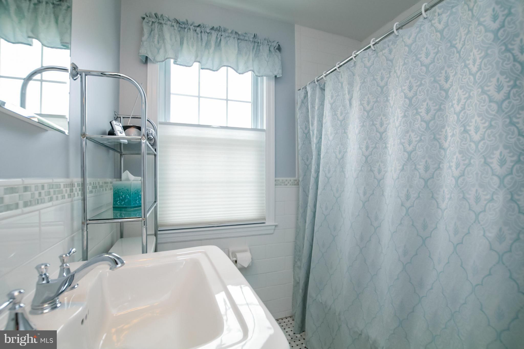 181 Dumbarton Road Baltimore, MD 21212 - Photo 6 of 30 a bathroom with a sink a vanity and a shower