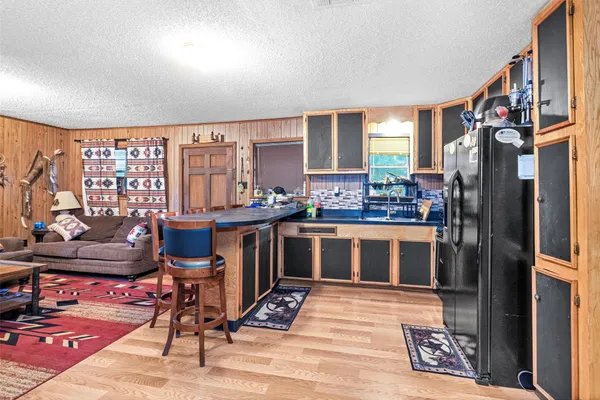 a living room with furniture flat screen tv and a table