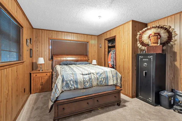 a bedroom with a bed and a mirror