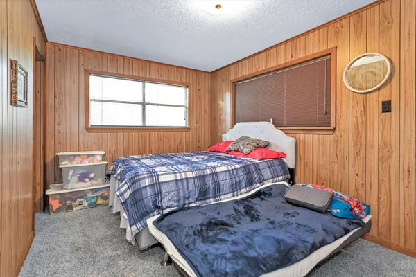 a bedroom with bed and a window
