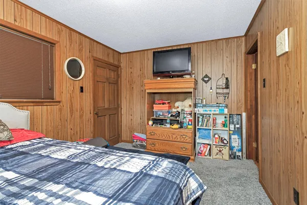 a bedroom with a bed and a television