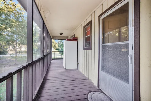 a view of a balcony with wooden floor