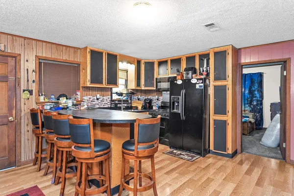 a kitchen with stainless steel appliances a refrigerator sink and cabinets