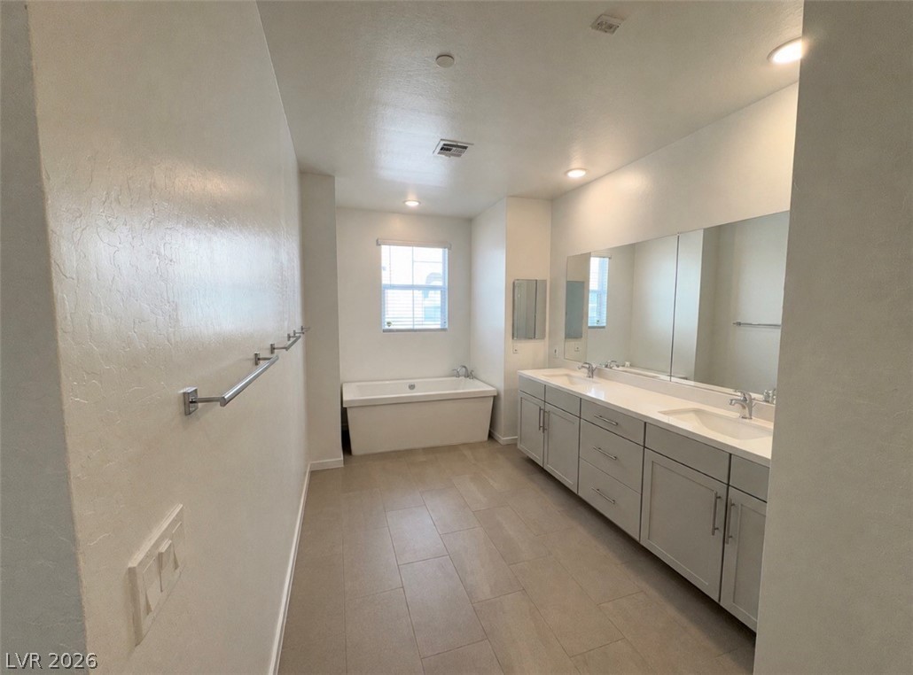 2555 Hampton Road, Unit 4205 Henderson, NV 89052 - Photo 25 of 52 This spacious bathroom offers a serene retreat with modern fixtures and ample natural light.
