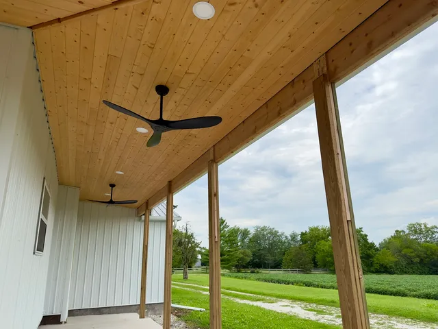 a view of a porch with a floor to ceiling window and a yard