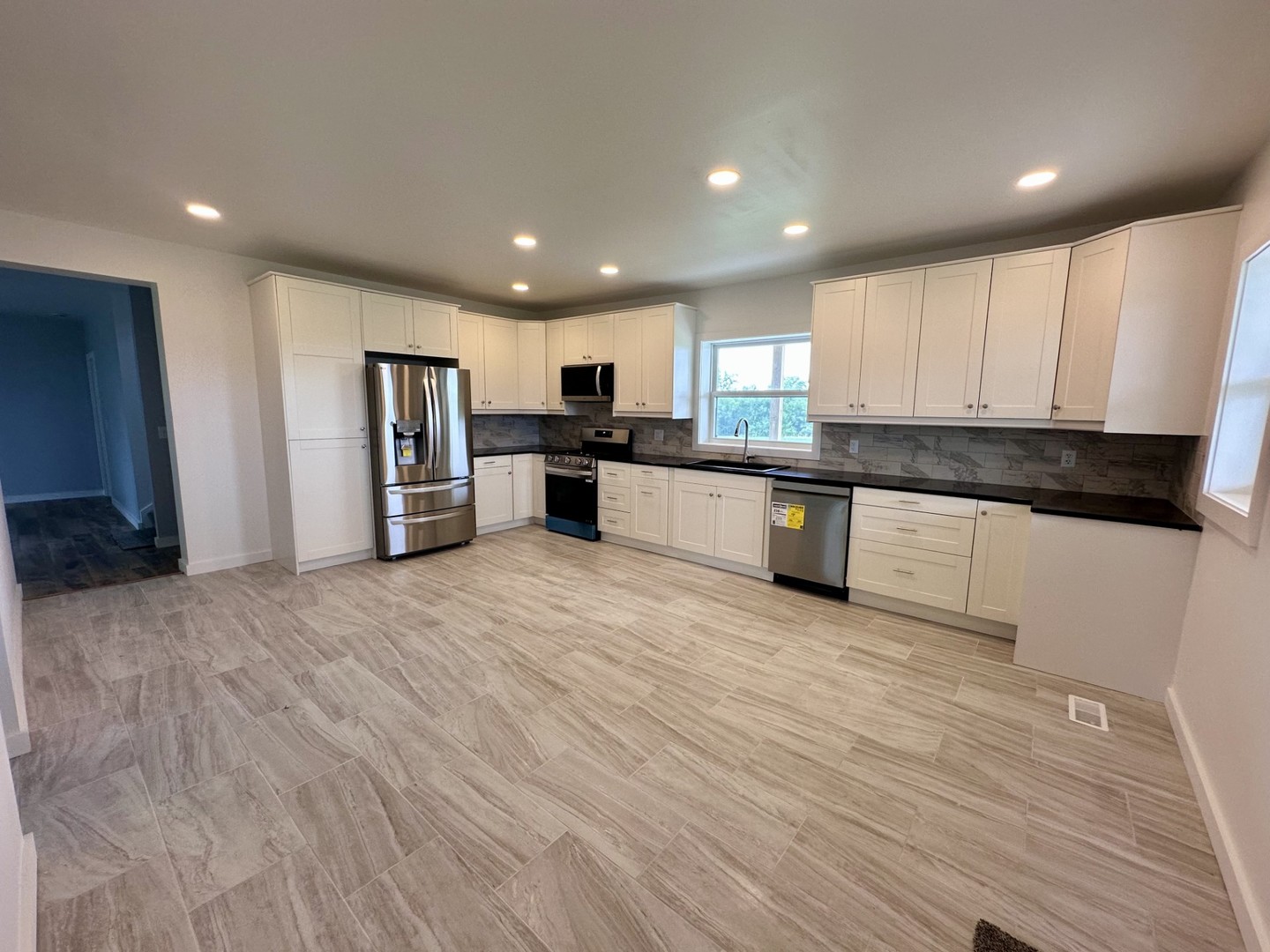 2452 East 350th Road Oglesby, IL 61348 - Photo 6 of 27 a large kitchen with stainless steel appliances granite countertop a stove a sink and a refrigerator