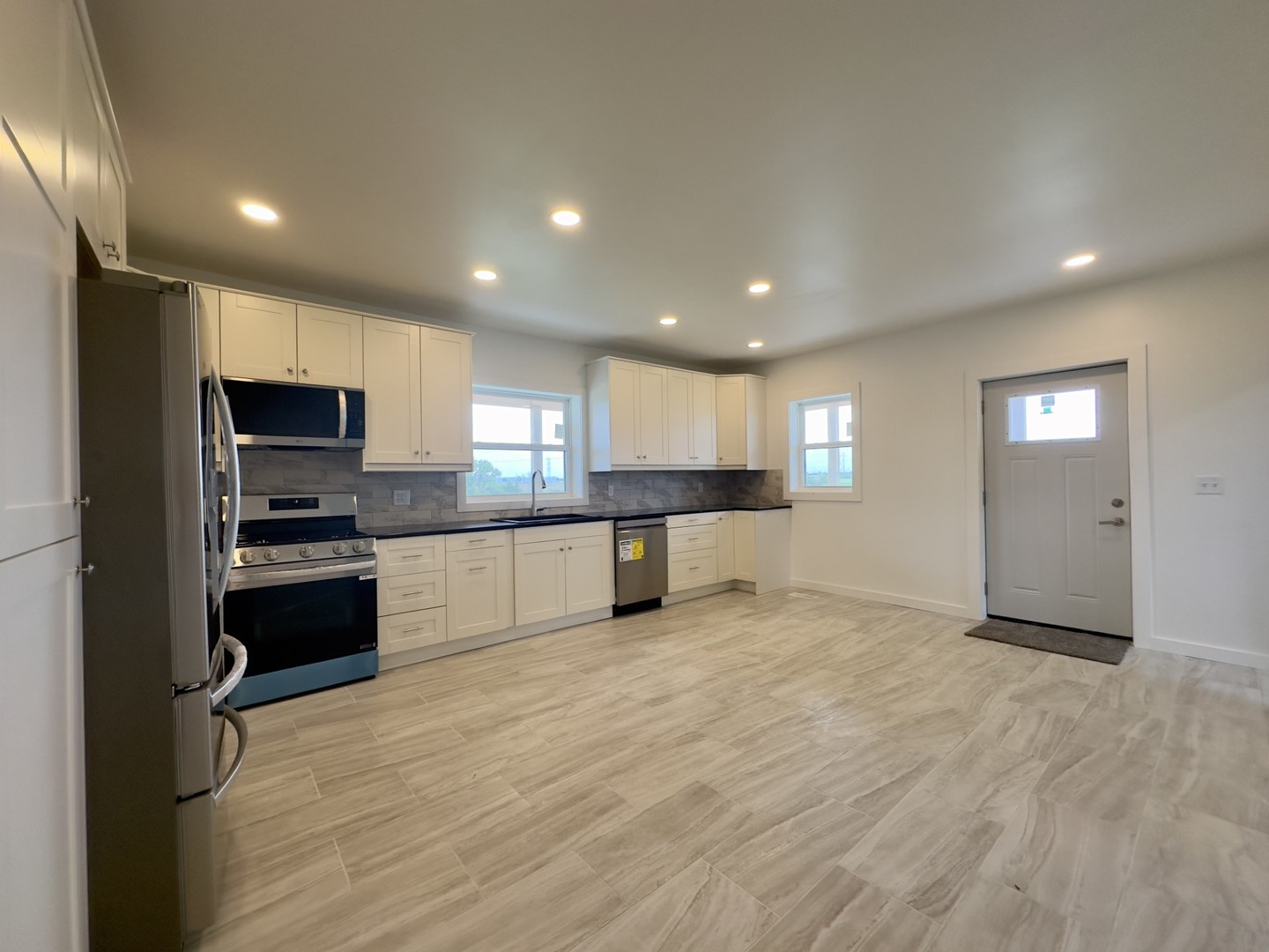 2452 East 350th Road Oglesby, IL 61348 - Photo 7 of 27 a view of an empty room with kitchen and window