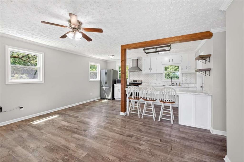 3696 Crabapple Hollow Road Nicholson, GA 30565 - Photo 4 of 38 a view of a dining room with furniture and a wooden floor