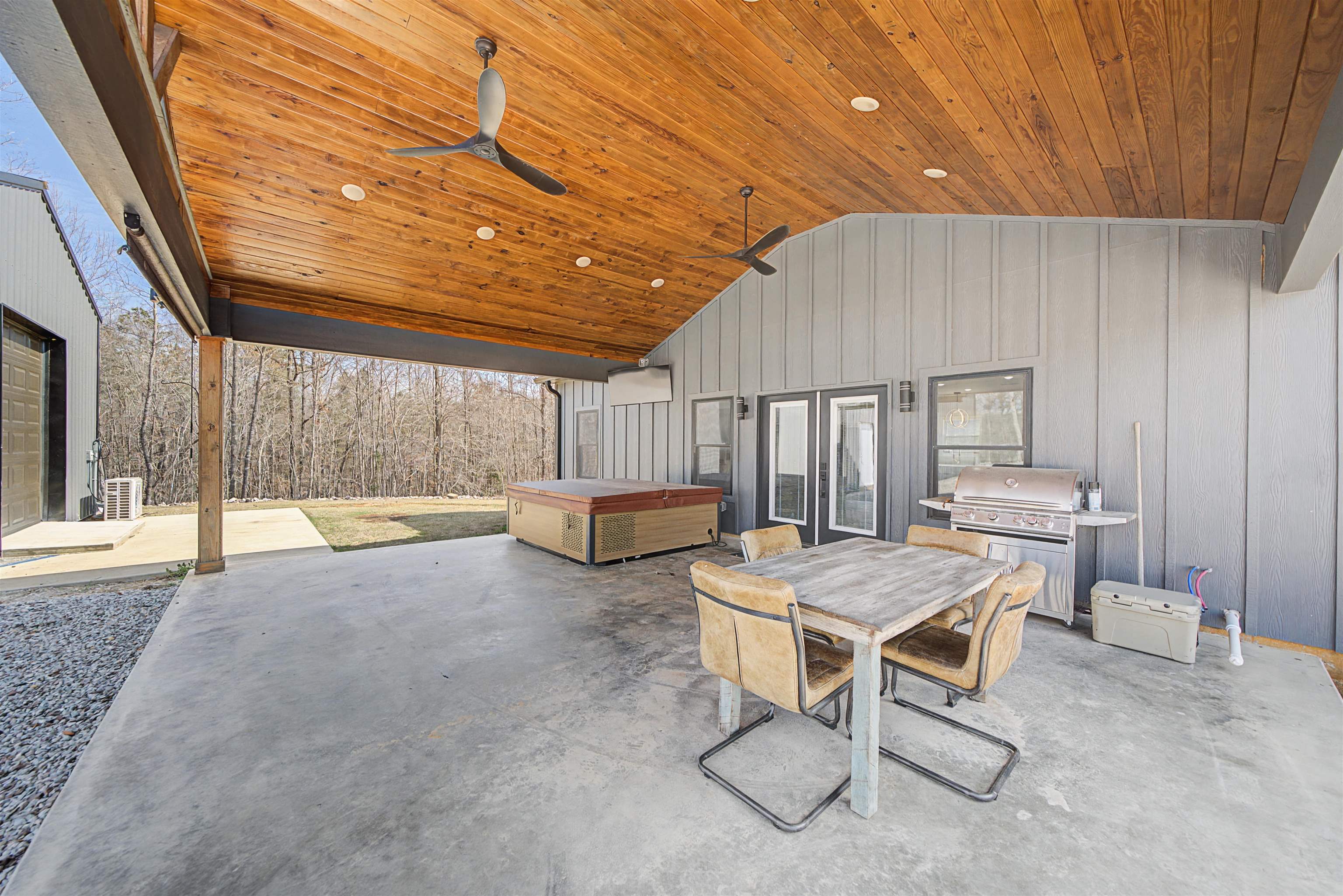 5439 Hines Gin Road Selmer, TN 38375 - Photo 3 of 33 a living room with furniture a flat screen tv and lawn chairs