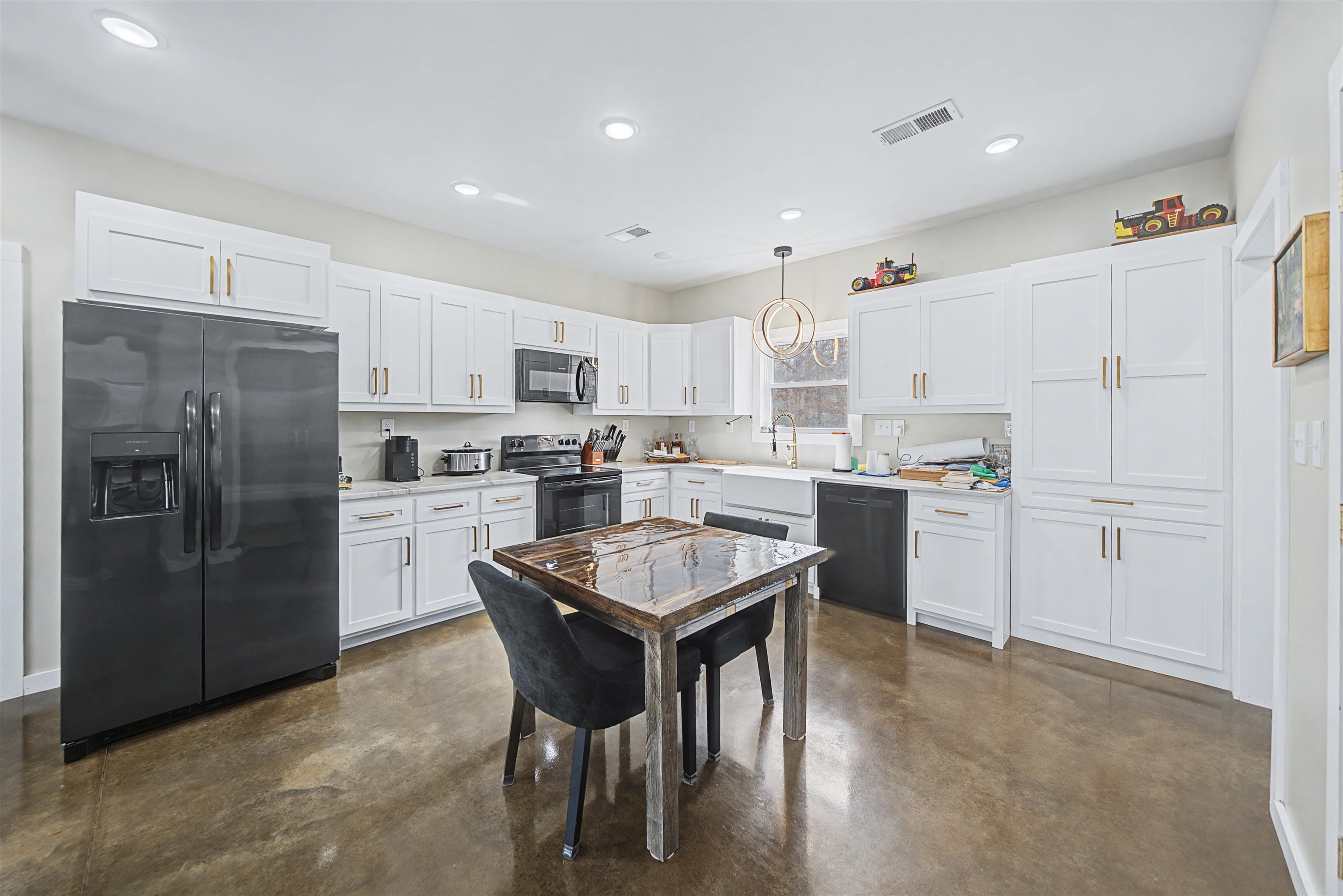 5439 Hines Gin Road Selmer, TN 38375 - Photo 10 of 33 a kitchen with a refrigerator a counter top space and a center island