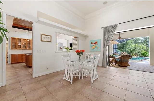 a dining room with furniture and a floor to ceiling window