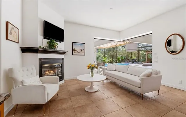 a living room with furniture a fireplace and a flat screen tv