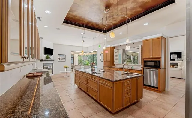 a large kitchen with stainless steel appliances granite countertop a large stove a sink and a refrigerator