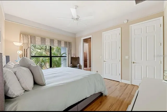 a large bed sitting in a bedroom next to a window