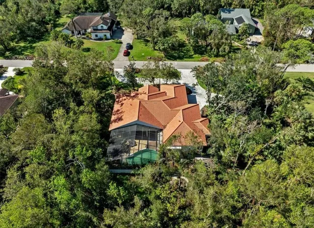 a view of a house with a small yard and potted plants