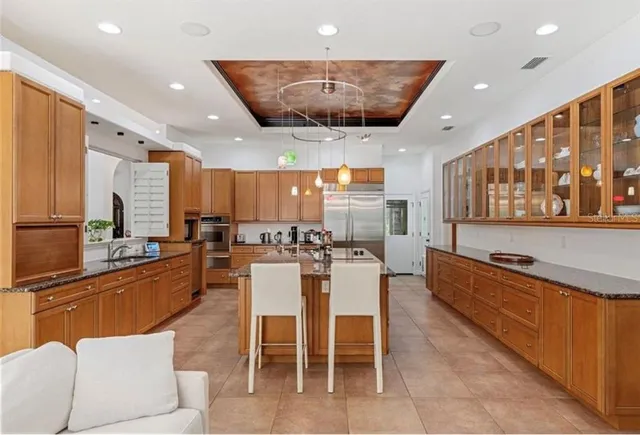 a large kitchen with a table and chairs