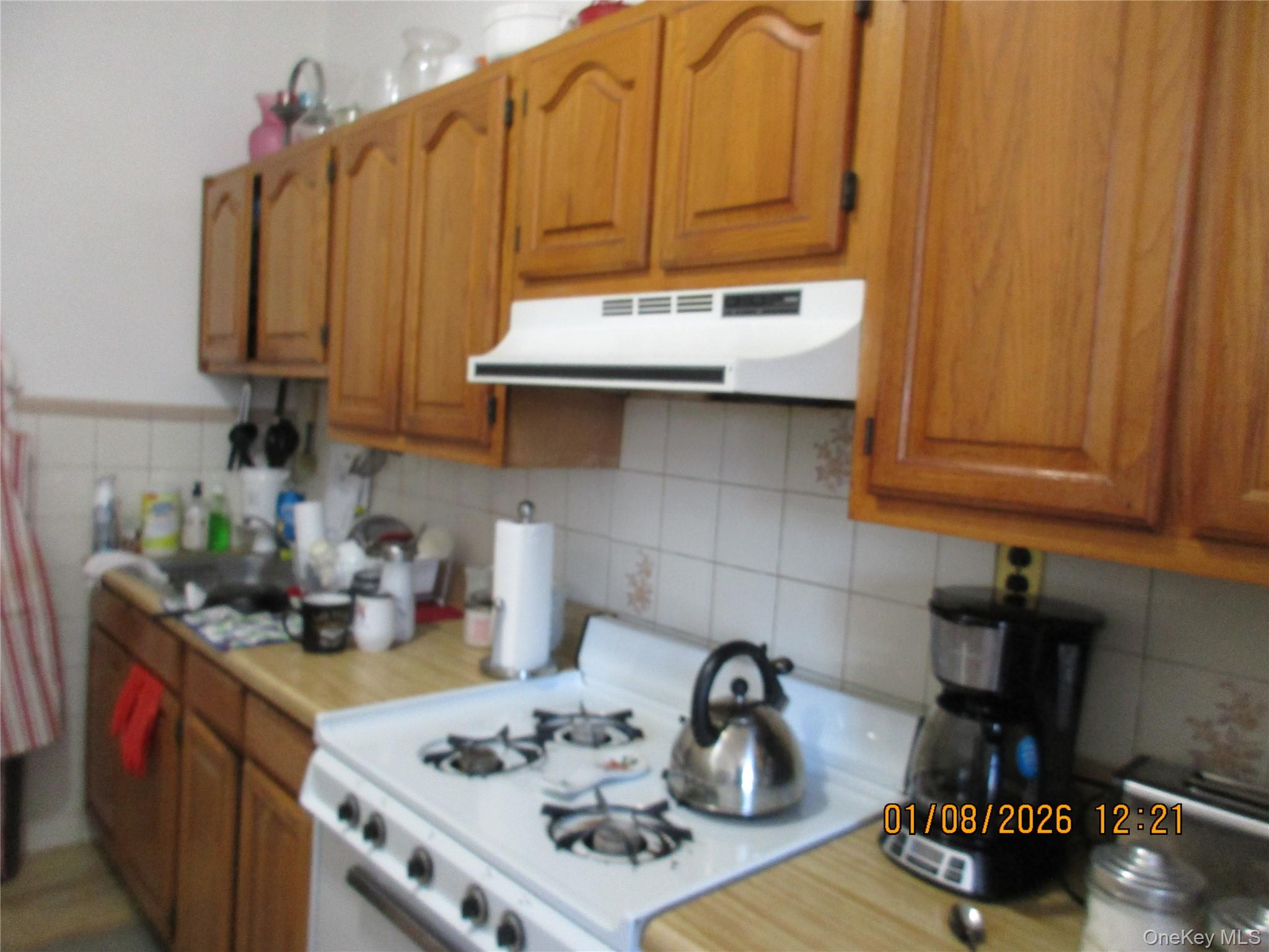 68-09 79th Street Queens, NY 11379 - Photo 14 of 15 a kitchen with a sink cabinets and appliances