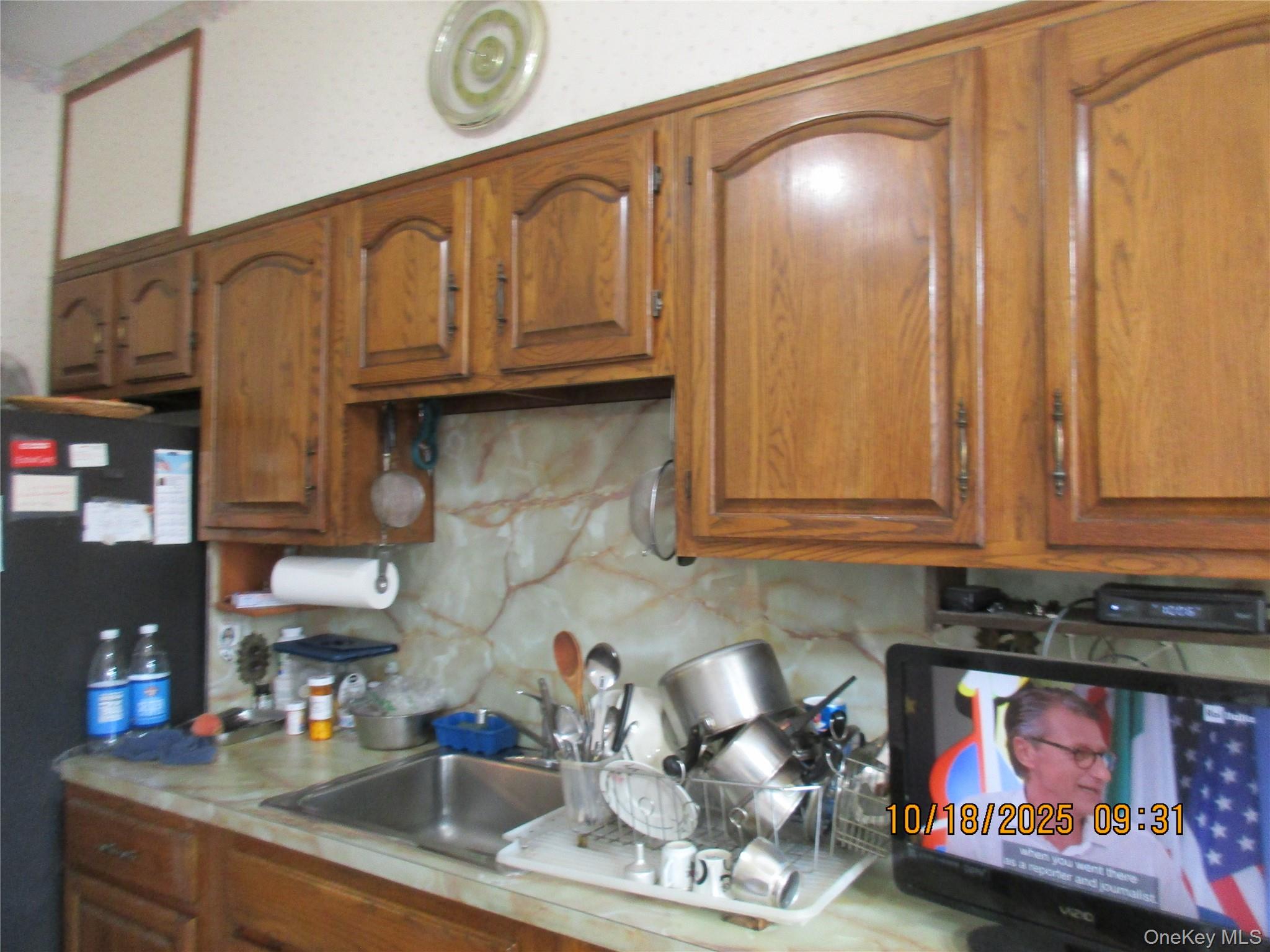 68-09 79th Street Queens, NY 11379 - Photo 6 of 15 a kitchen with stainless steel appliances granite countertop a sink and cabinets