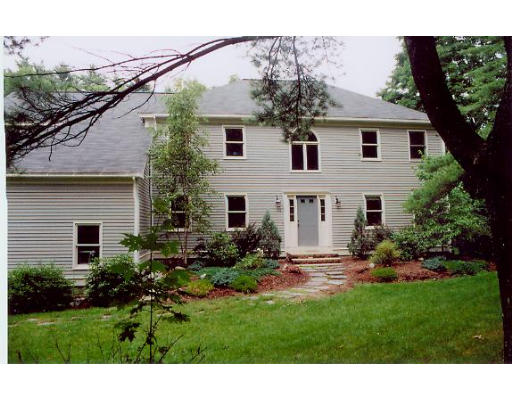 a view of a house with backyard and garden