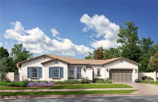 a front view of a house with a garden and trees