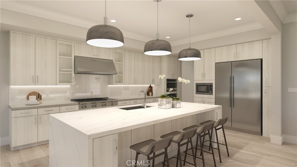 6525 Etiwanda Avenue Rancho Cucamonga, CA 91739 - Photo 4 of 9 a kitchen with a dining table cabinets and appliances