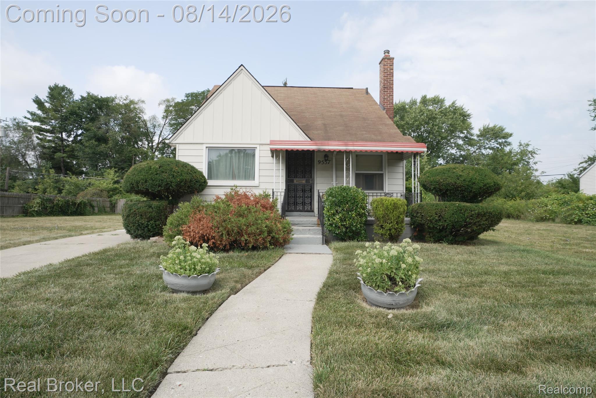 9557 Meyers Road Detroit, MI 48227 - Photo 1 of 23 Charming cottage-style home featuring a cream and burgundy exterior with a pitched roofline and brick chimney