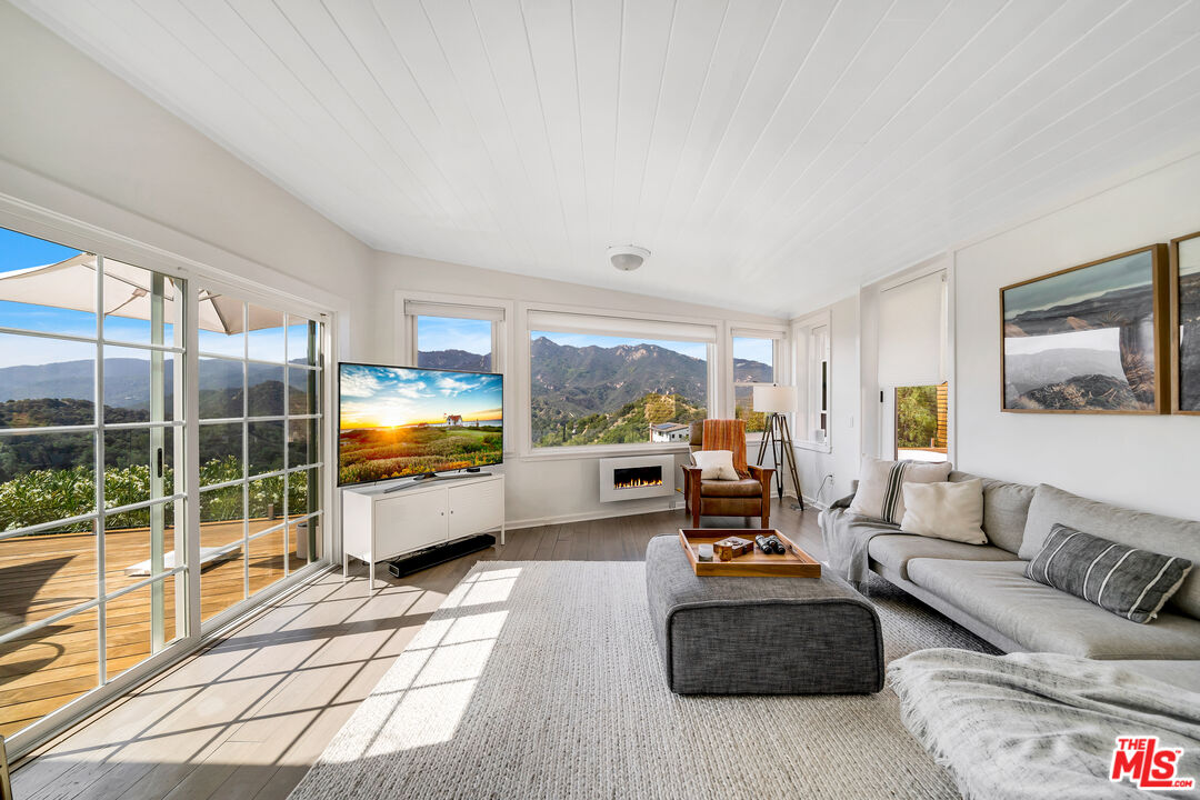 2016 Mt Prospect Drive Topanga, CA 90290 - Photo 17 of 41 a living room with furniture and a flat screen tv