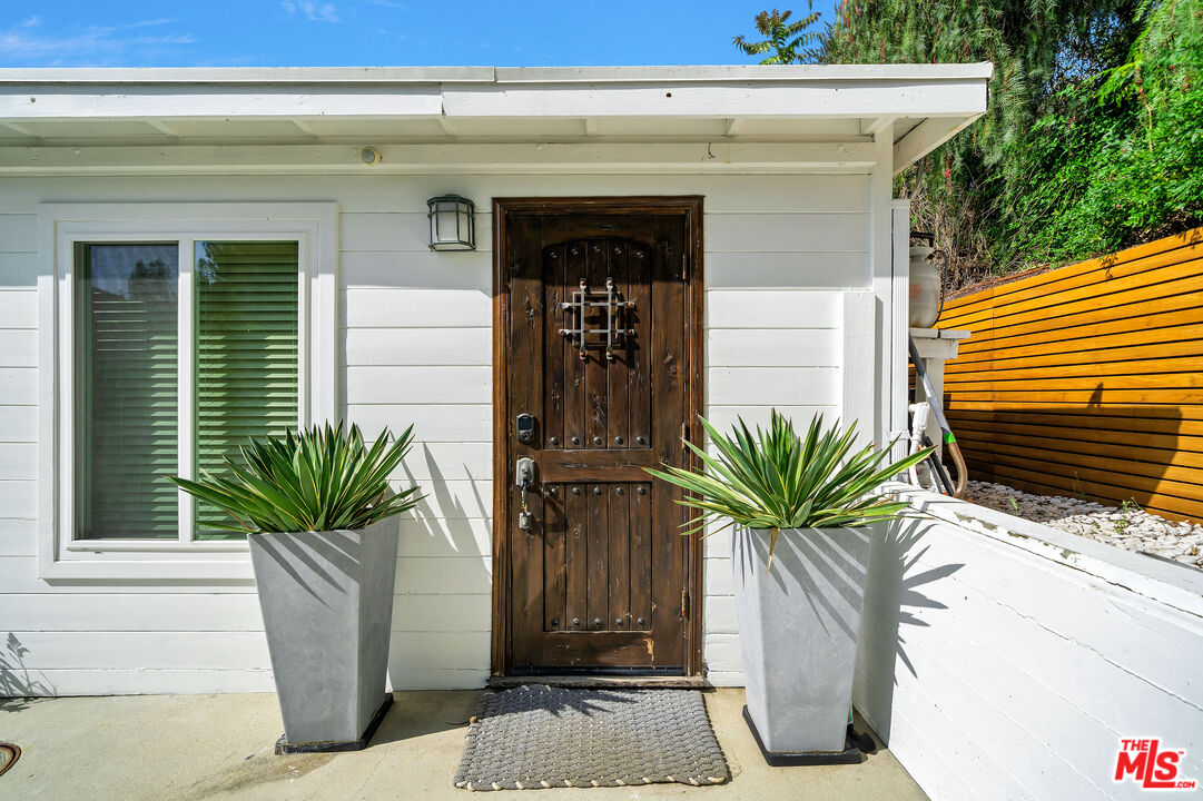 2016 Mt Prospect Drive Topanga, CA 90290 - Photo 4 of 41 a vase of flowers sitting on a floor