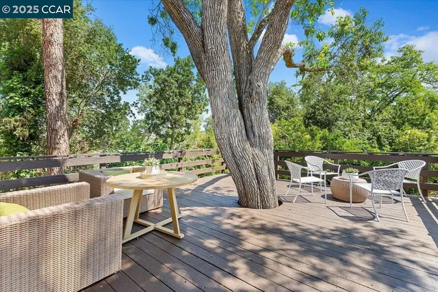 a view of backyard of house with seating space