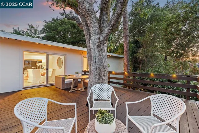 a backyard of a house with table and chairs