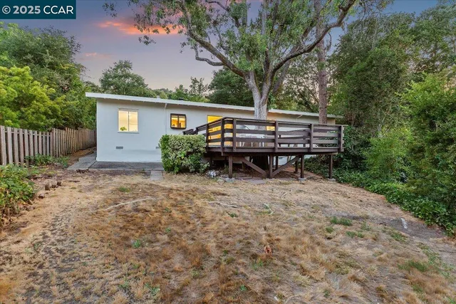 a view of a chairs and table in the backyard
