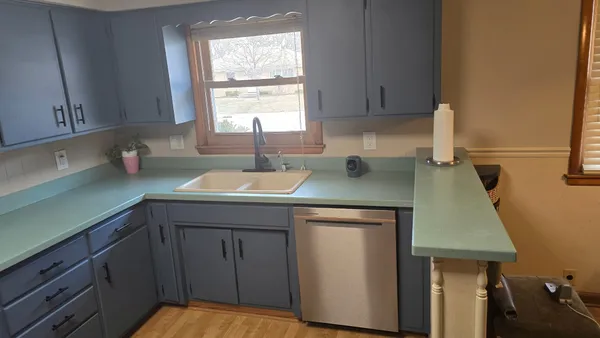 a kitchen with a sink cabinets and window