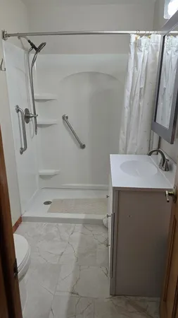 a bathroom with a shower and a sink