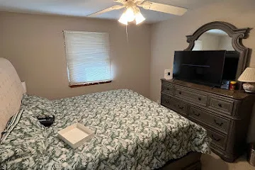 a bedroom with a bed and a flat screen tv