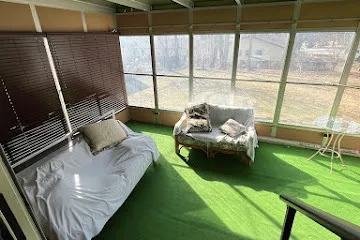 a living room with furniture and a floor to ceiling window