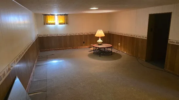 a view of a livingroom with wooden floor and a window