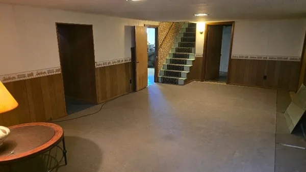 a view of an empty room and a bathroom