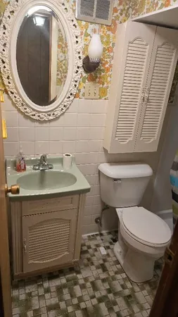 a bathroom with a toilet and a sink