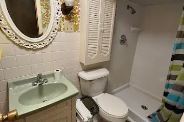 a white toilet sitting next to a bathroom sink