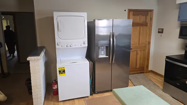 a kitchen with a refrigerator and microwave