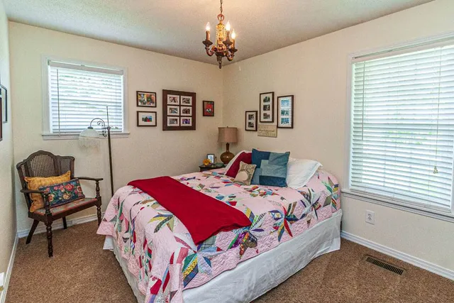 a bedroom with bed and a window