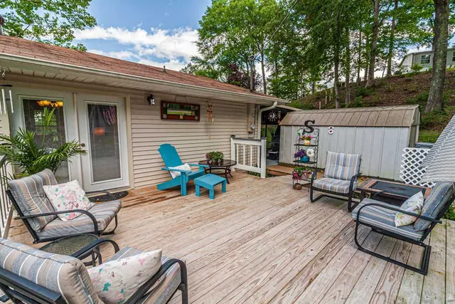 a view of a patio with couple of chairs and a wooden floor