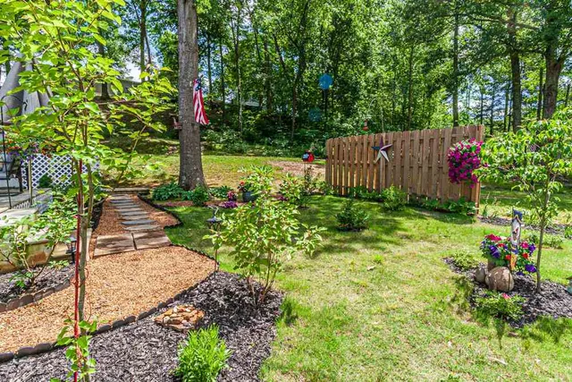 a view of a garden with wooden fence