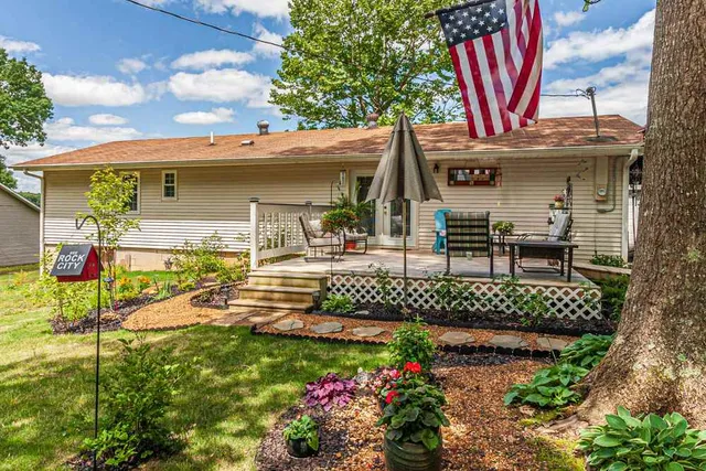 a view of a house with a porch and furniture