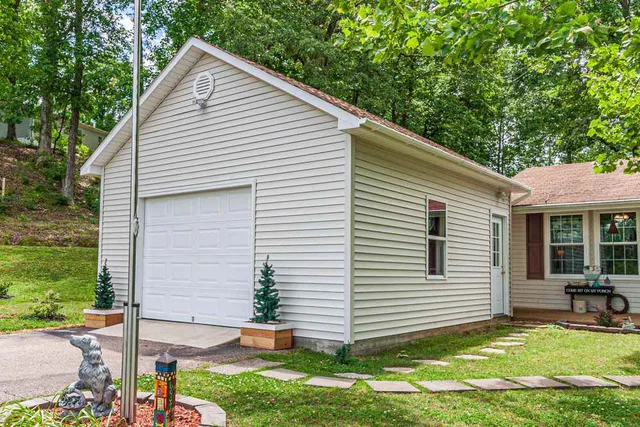 a view of a house with yard and sitting area