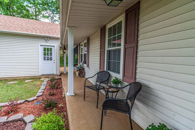 a view of backyard with outdoor seating and green space