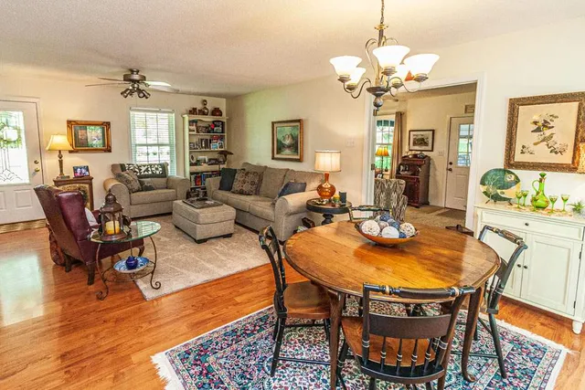 a living room with fireplace furniture and a chandelier